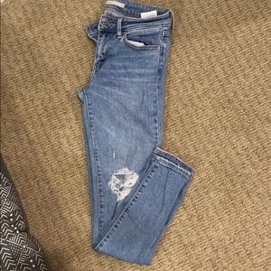 Levis 711 skinny jean with a few rips